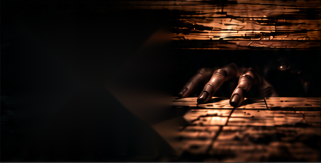 A hand reaching out from beneath weathered wooden floorboards.